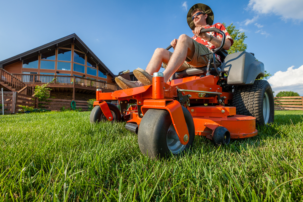 man using a zero turn mower