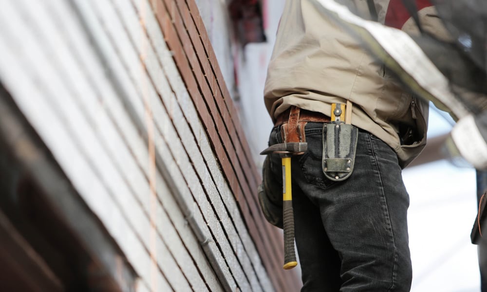 A workman wearing a tool belt
