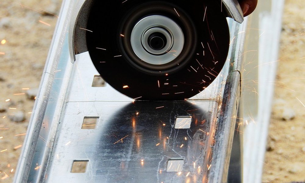 Angle grinder cutting through metal