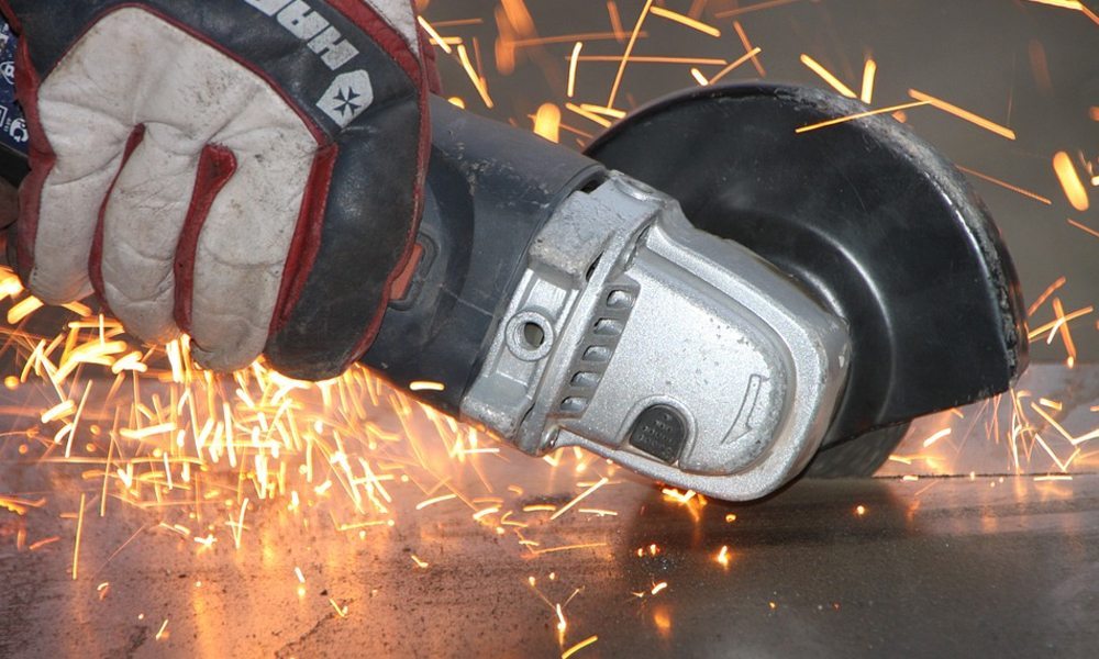 angle grinder cutting with sparks coming off the metal